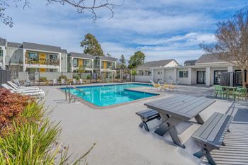 a swimming pool with a picnic table and chairs around it at Napa Green Apartments LLC, Napa, CA 94559